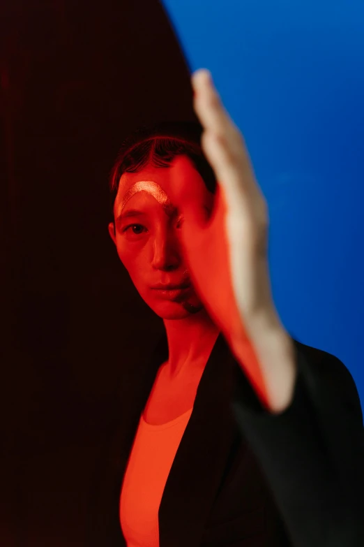 a woman standing in front of a red light, an album cover, inspired by Gao Cen, wonbin lee, close portrait, red and blue, ignant