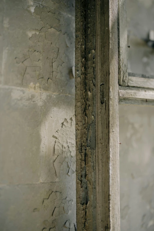 a white toilet sitting inside of a bathroom next to a window, a detailed painting, inspired by Richter, unsplash, graffiti, close-up print of fractured, smouldering charred timber, in a monestry natural lighting, close up 1 9 9 0