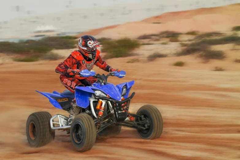 a man riding on the back of a blue atv, a picture, by Jeffrey Smith, trending on reddit, fine art, panoramic shot, las vegas, raptor, red sand