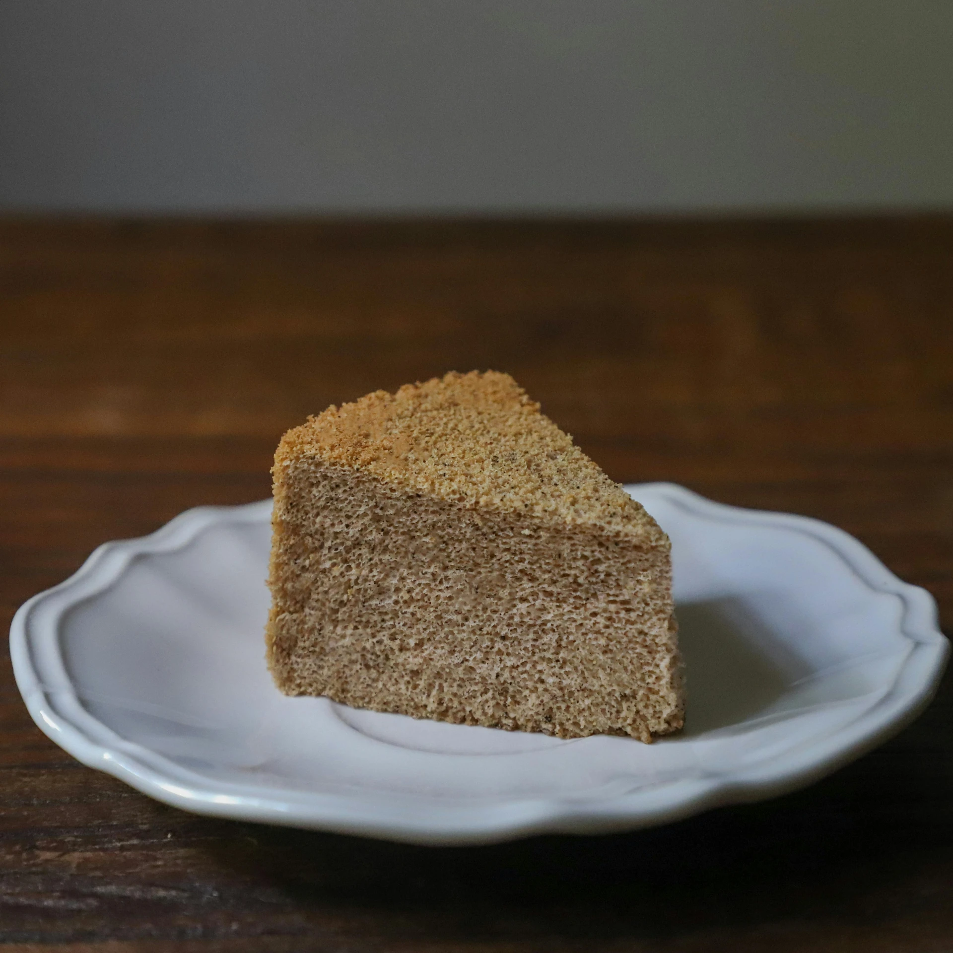 a piece of cake sitting on top of a white plate, shin hanga, sand, product image, bakery, post processed