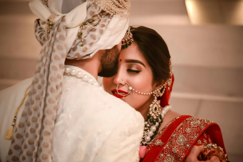 a woman in a red sari hugging a man in a white turban, pexels contest winner, hurufiyya, couple kissing, decoration, profile image, pretty face!!