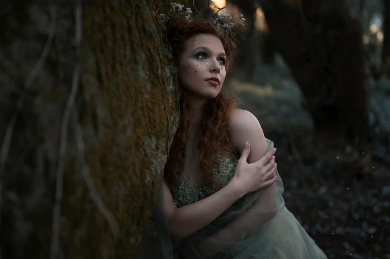a woman in a green dress leaning against a tree, inspired by Arthur Hughes, pexels contest winner, renaissance, ( redhead, todd hido photography, the moonlit dance of the fae, various posed