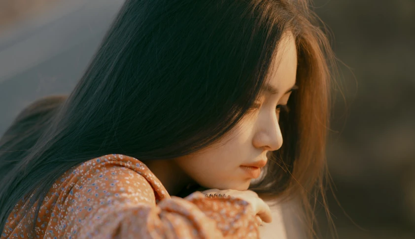 a close up of a person with long hair, inspired by Elsa Bleda, trending on pexels, realism, korean girl, pensive, thoughtful pose, fujicolor photo