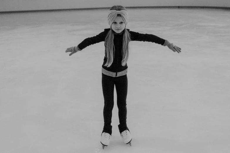 a black and white photo of a girl on a skateboard, a black and white photo, pixabay, ice queen, standing in an arena, erin moriarty, little girl