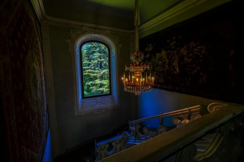 a bath room with a chandelier and a window, inspired by Elsa Bleda, unsplash contest winner, rococo, stairway to heaven, photo taken at night, lush surroundings, taken in the early 2020s