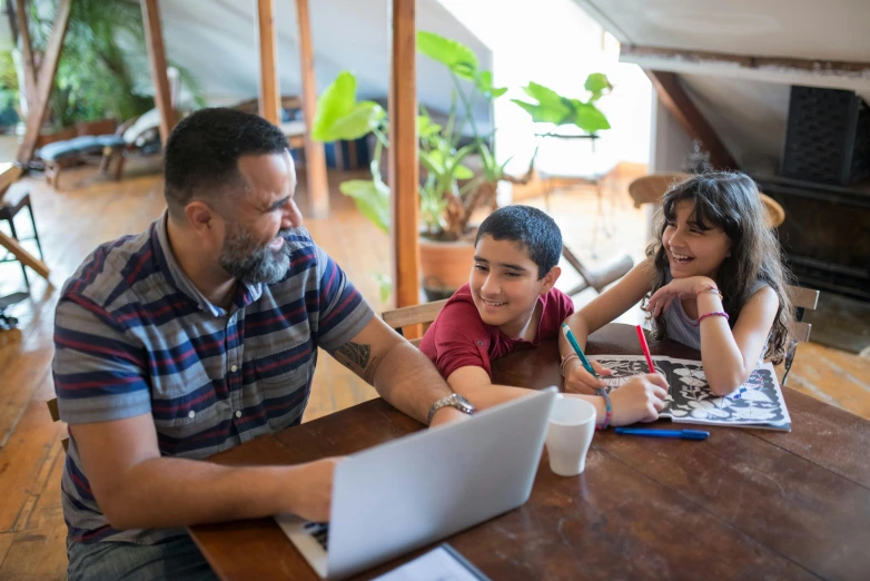 a man and two children sitting at a table with a laptop, pexels contest winner, te pae, maths, environmental shot, hispanic