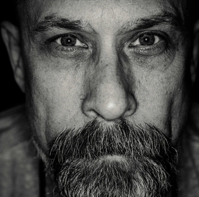 a black and white photo of a man with a beard, a black and white photo, unsplash, hyperrealism, todd mcfarlane, shaved head, marc silvestri, serious lighting