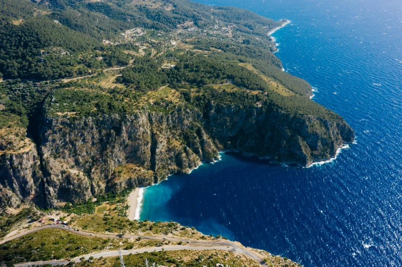 a large body of water next to a lush green hillside, pexels contest winner, les nabis, greek nose, navy, aerial, conde nast traveler photo