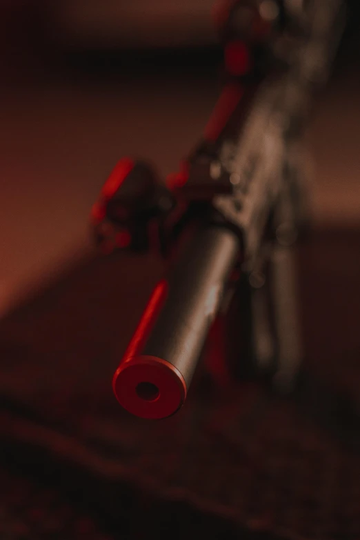 a toy gun sitting on top of a book, red atmosphere, up-close, long muzzle, shot with sony alpha