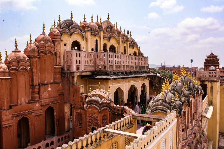 a group of people standing in front of a building, inspired by Steve McCurry, pexels contest winner, renaissance, pink arches, palace on top of the hill, hindu ornaments, thumbnail