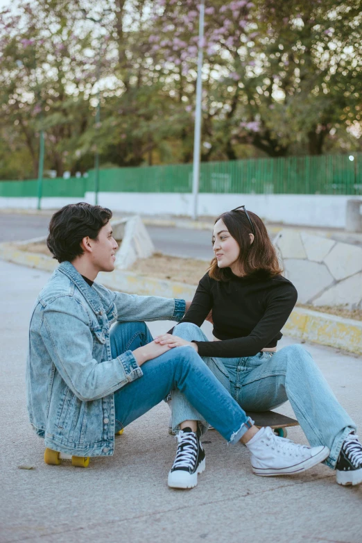 a man and a woman sitting on a skateboard, trending on pexels, realism, chile, ✨🕌🌙, profile image, wearing jeans