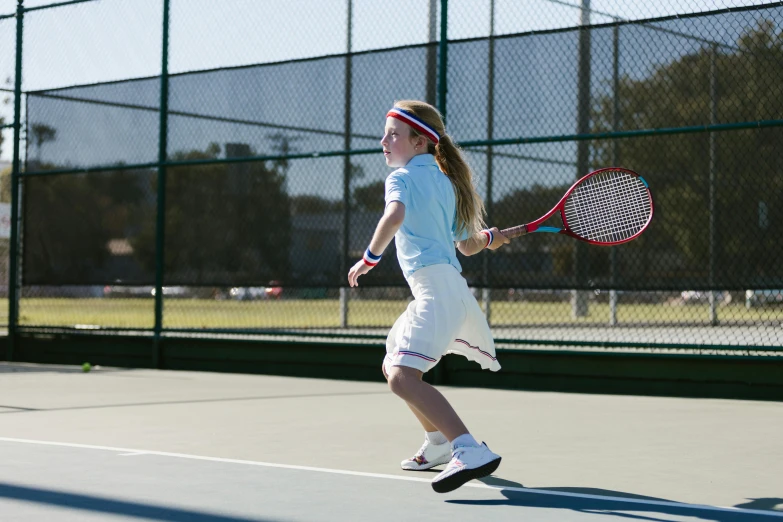 a young girl holding a tennis racquet on a tennis court, unsplash, american barbizon school, panning shot, shot with canon 5 d mark ii, lachlan bailey, panels