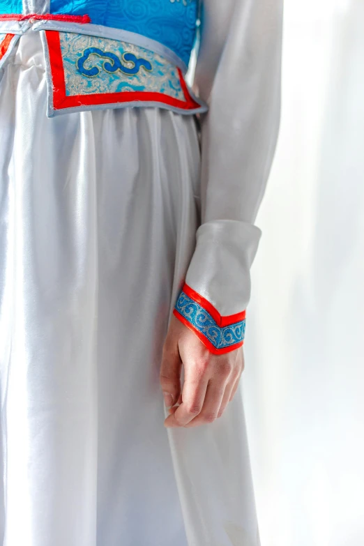 a woman in a blue and white dress, red neon details, wearing a white folkdrakt dress, close up image, wearing a grey robe