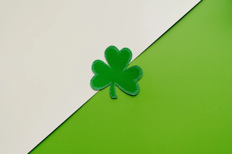 a four leaf clover on a green and white background, inspired by Ellsworth Kelly, trending on pexels, hurufiyya, silicone patch design, foil, 33mm photo