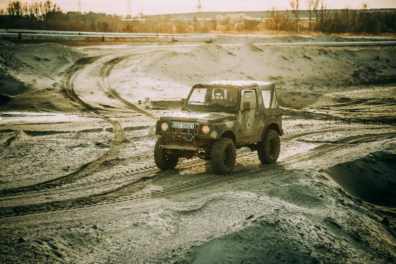 a jeep driving down a dirt road on a sunny day, by Adam Marczyński, unsplash, soviet nostalgia, wet mud, performance, square