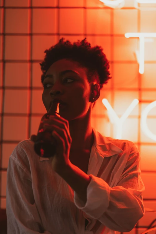 a woman holding a microphone in front of a neon sign, pexels contest winner, black young woman, light red and orange mood, androgynous male, lonely vibe