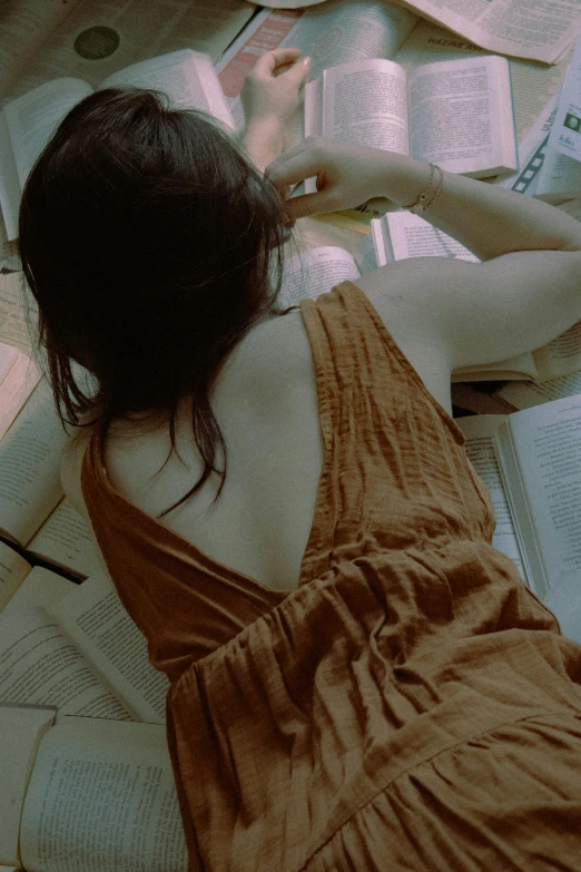 a woman laying on a bed reading a book, by Mei Qing, pexels contest winner, renaissance, showing her shoulder from back, sundress, gif, ulzzang