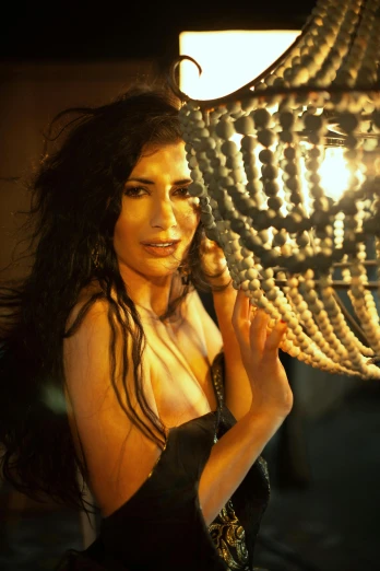 a woman holding a chandelier over her head, glamorous tifa lockheart, middle eastern skin, still from a music video, side light