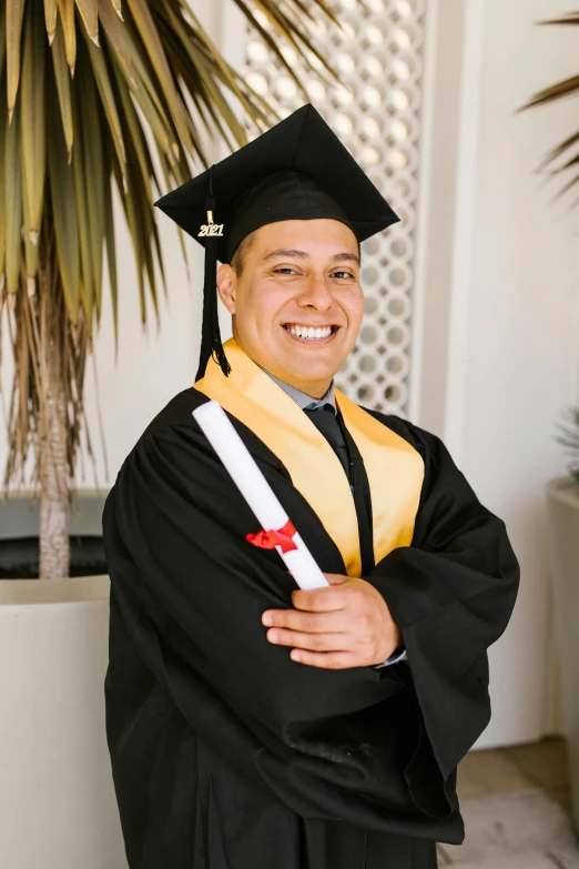 a man in a graduation gown posing for a picture, alanis guillen, portrait image, zigor samaniego