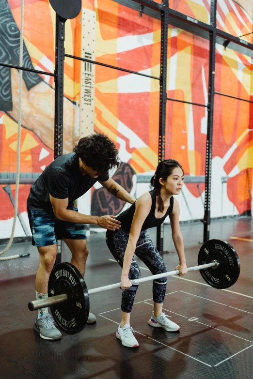 a couple of people in a gym with a barbell, by Reuben Tam, square, kuang hong, high-quality photo, jenna barton