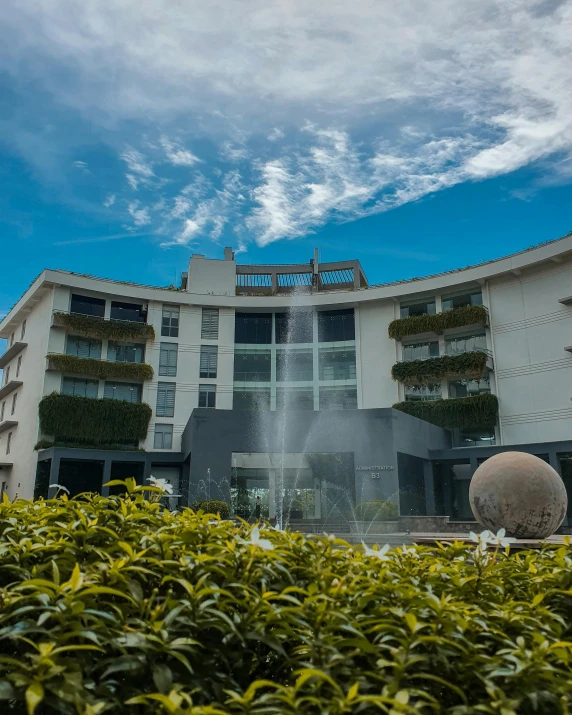 a building with a fountain in front of it, hotel room, marbella, on a bright day, thumbnail