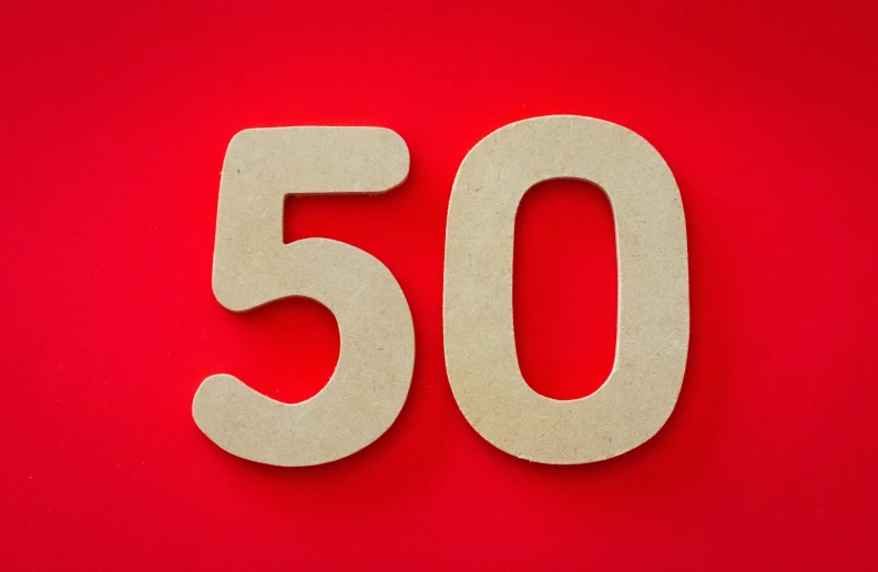 a wooden number fifty on a red background, by Daniel Lieske, pixabay, 50 years old men, sustainable materials, 50 shades, papa john eating 50 pizzas a day