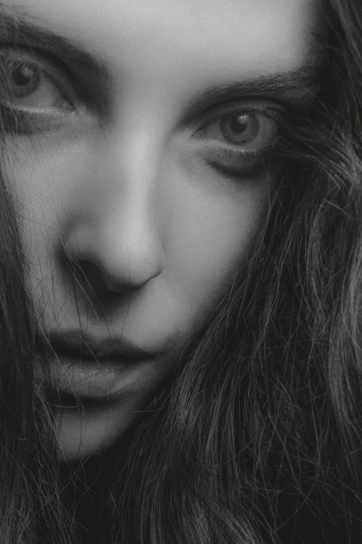 a black and white photo of a woman with long hair, inspired by irakli nadar, extreme close up face shot, wide eyed, shy looking down, gloomy face