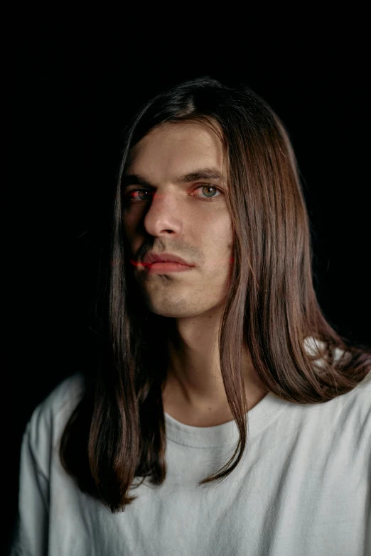 a man with long hair wearing a white shirt, unsplash, hyperrealism, symmetrical face orelsan, andrea savchenko, as a vampire, photographed for reuters