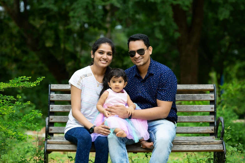 a man and woman sitting on a bench with a baby, pexels, hurufiyya, portrait image, vinayak, square, medium details