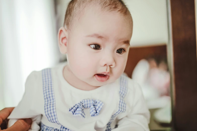 a close up of a person holding a baby, looking the camera, wan adorable korean face, cute pout, with mouth open