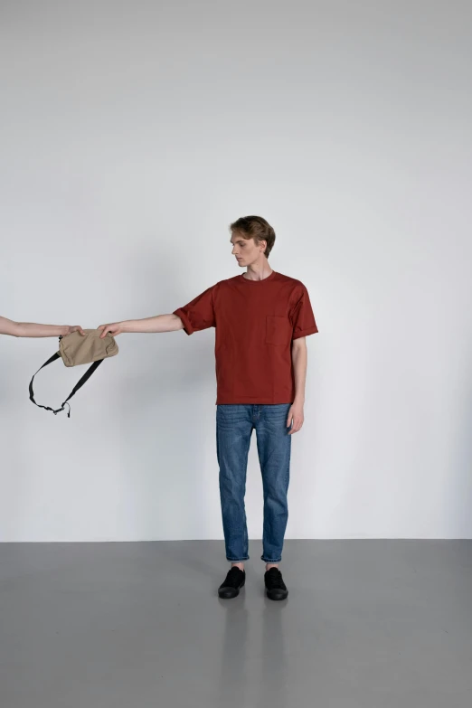 a man and a woman holding hands in a room, by Tobias Stimmer, red shirt brown pants, trending on r/streetwear, very minimal, bags