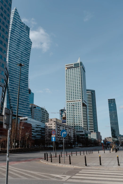 a city street filled with lots of tall buildings, warsaw, gigantic tower, taken with sony alpha 9, high quality image