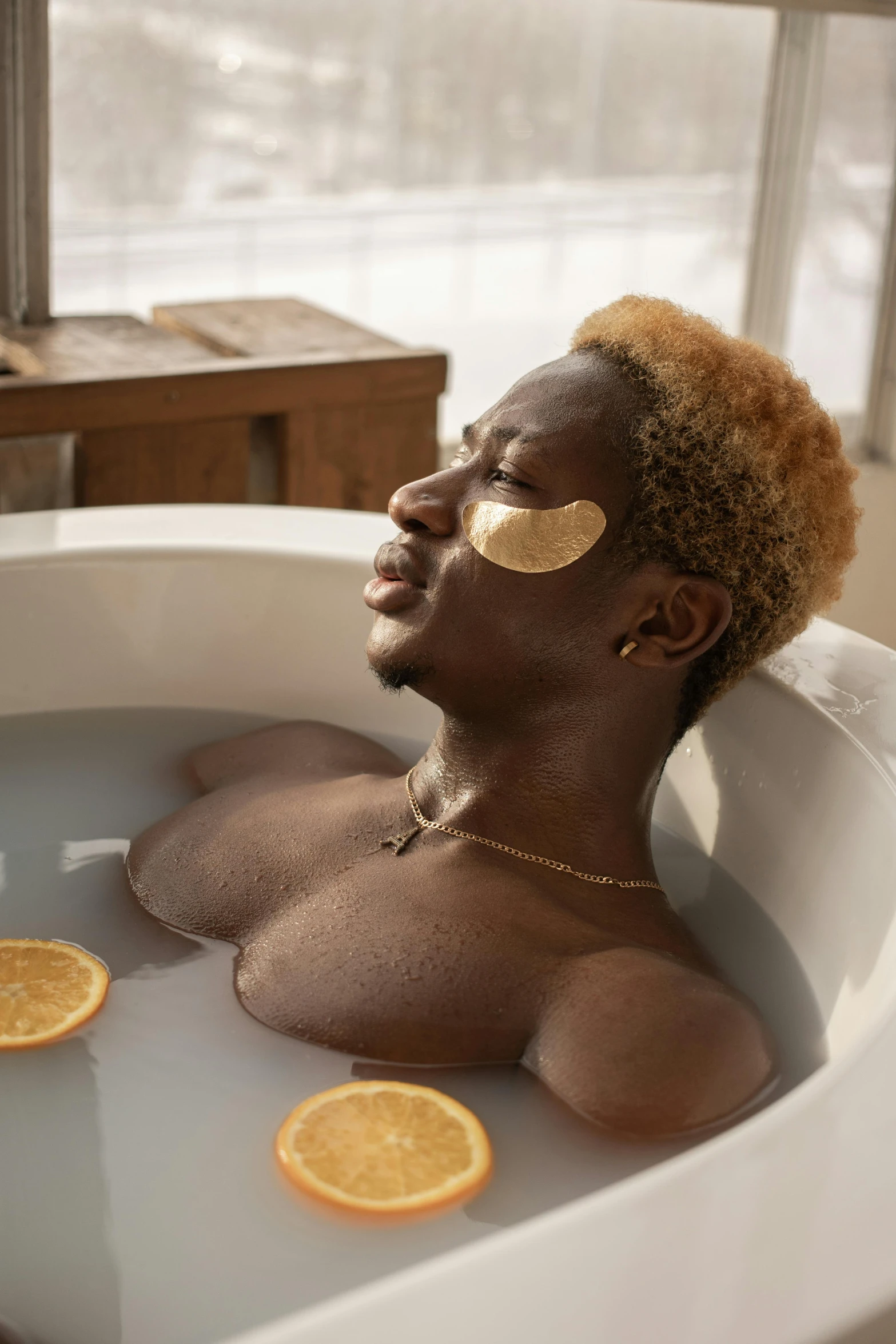 a woman in a bathtub with orange slices on her face, trending on pexels, afrofuturism, beautiful man, eyepatches, swimming in a pool of coffee, short blonde afro