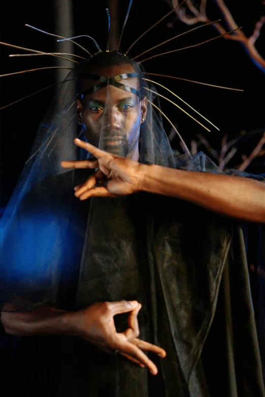 a close up of a person in a costume, by Ingrida Kadaka, he is casting a lighting spell, backdrop, hands shielding face, slide show