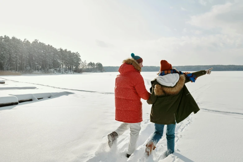 a couple of people walking across a snow covered field, lake view, gen z, instagram post, easy to use