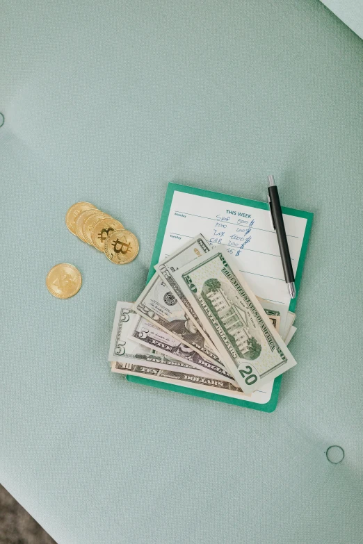 a pile of money sitting on top of a table, seafoam green, - 8