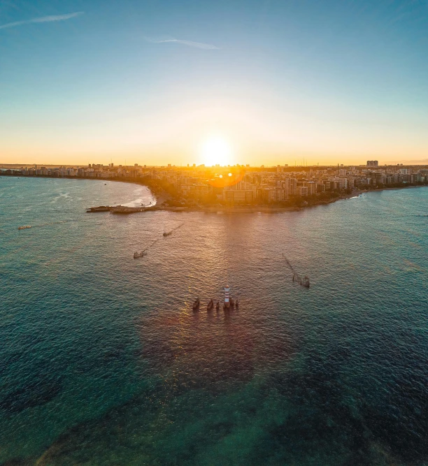 a group of people standing on top of a body of water, by Robbie Trevino, pexels contest winner, hurufiyya, manly, ultra wide angle horizon, late afternoon sun, aerial