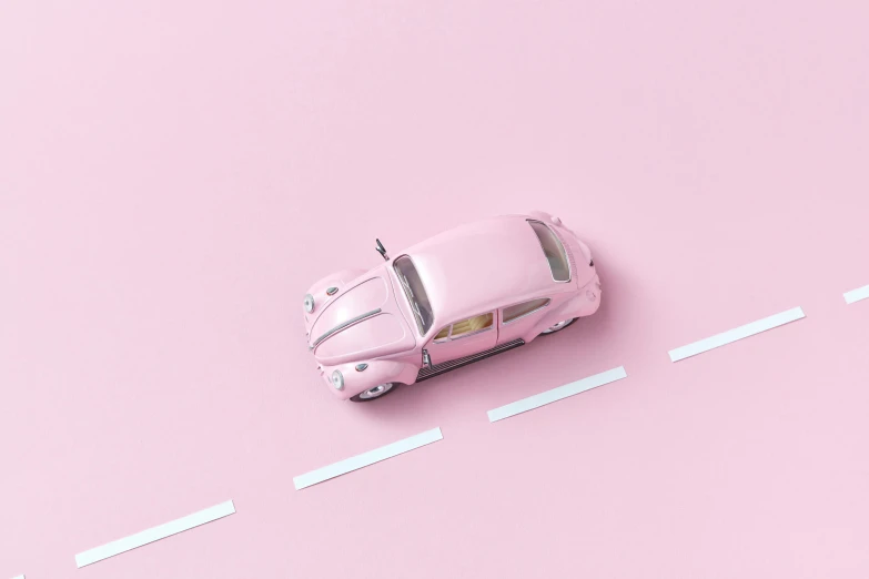 a pink toy car sitting on top of a pink surface, inspired by Chris LaBrooy, pexels contest winner, car traffic, beetle, hiperrealista, hyperminimalist