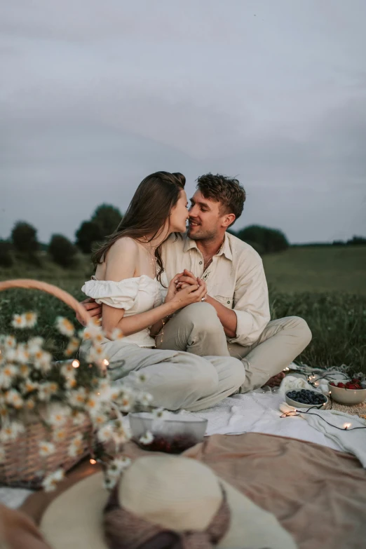 a man and woman sitting on a blanket in a field, pexels contest winner, romanticism, licking, fine dining, flirting, flowers around