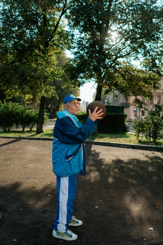 a man in a blue jacket throwing a frisbee, by Carlo Martini, dribble contest winner, an 80 year old man, milan jozing, wearing basketball jersey, 15081959 21121991 01012000 4k