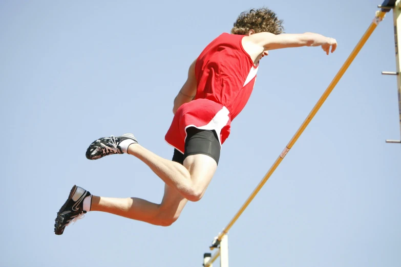 a man that is in the air with a pole, high arches, high quality product image”, in a race competition, istock