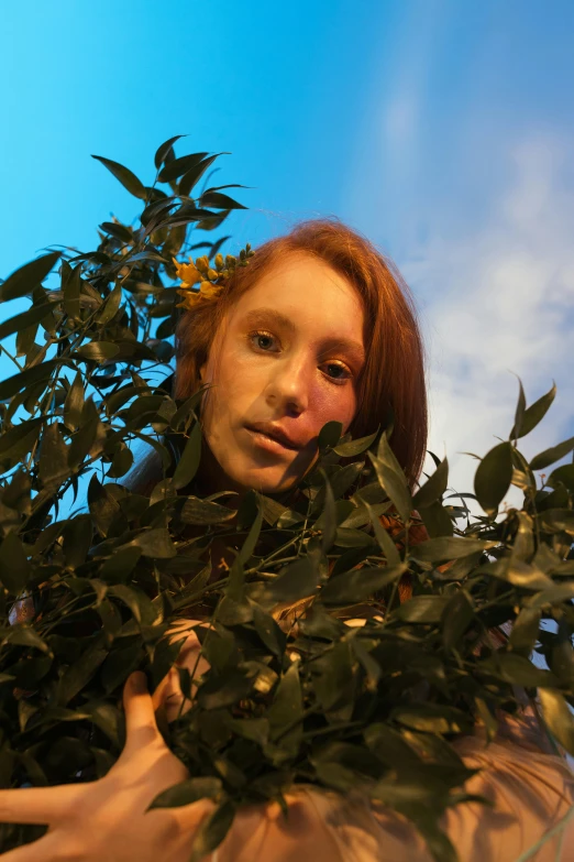 a close up of a person holding a plant, an album cover, inspired by Cindy Sherman, photorealism, red haired young woman, blue sky, aerochrome eyes, greta thunberg