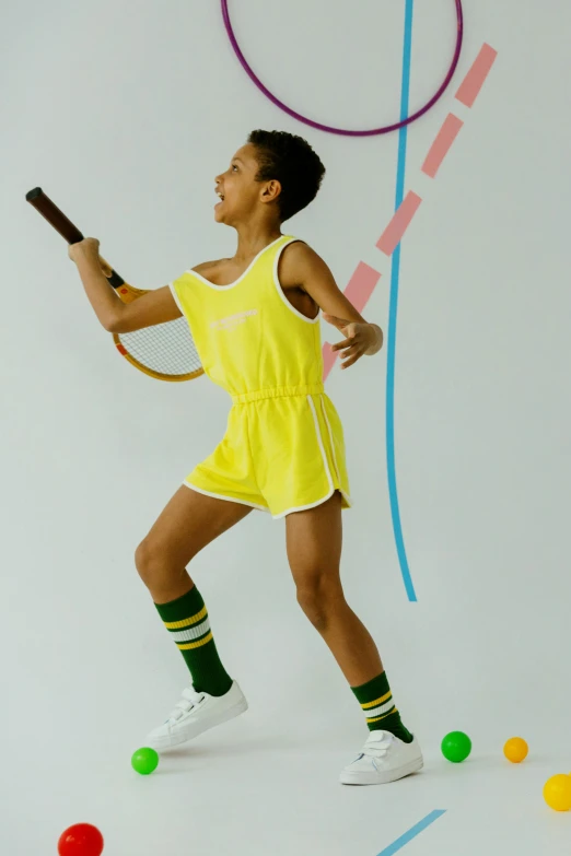 a young man holding a tennis racquet on top of a tennis court, an album cover, by Ellen Gallagher, leotard and leg warmers, colors: yellow, dafne keen, and