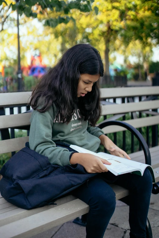 a girl sitting on a bench reading a book, riyahd cassiem, academic clothing, jc park, for junior