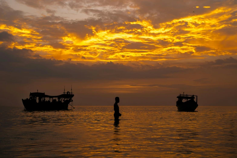 a couple of boats floating on top of a body of water, by Jan Tengnagel, pexels contest winner, girl watching sunset, fishing village, detailed silhouette, national geographic photo award