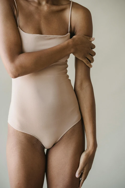 a woman in a nude bodysuit posing for a picture, by Nina Hamnett, unsplash, renaissance, soft blush, wearing leotard, angled, detailed product image