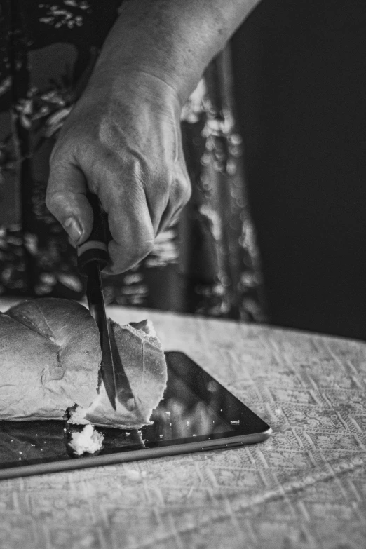 a person cutting a turkey on a cutting board, a black and white photo, unsplash, hyperrealism, bread, smartphone photography, digging, potrait