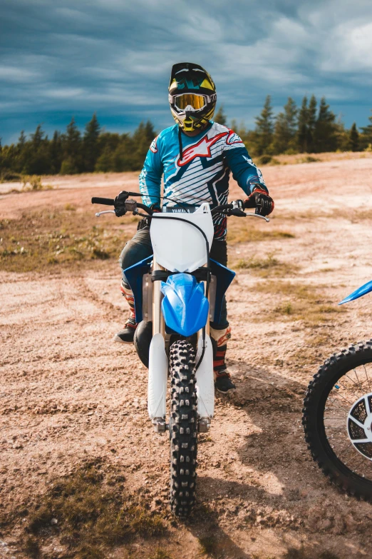 two people riding dirt bikes on a dirt road, grey and blue theme, vehicles, detailing, black