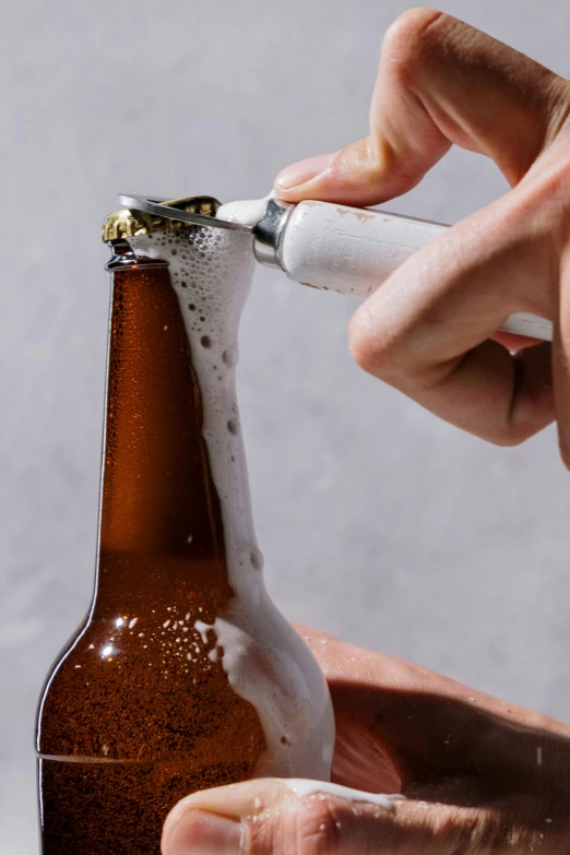 a close up of a person opening a bottle of beer, by Ben Zoeller, process art, official product photo, shaven, innovative, detailed white