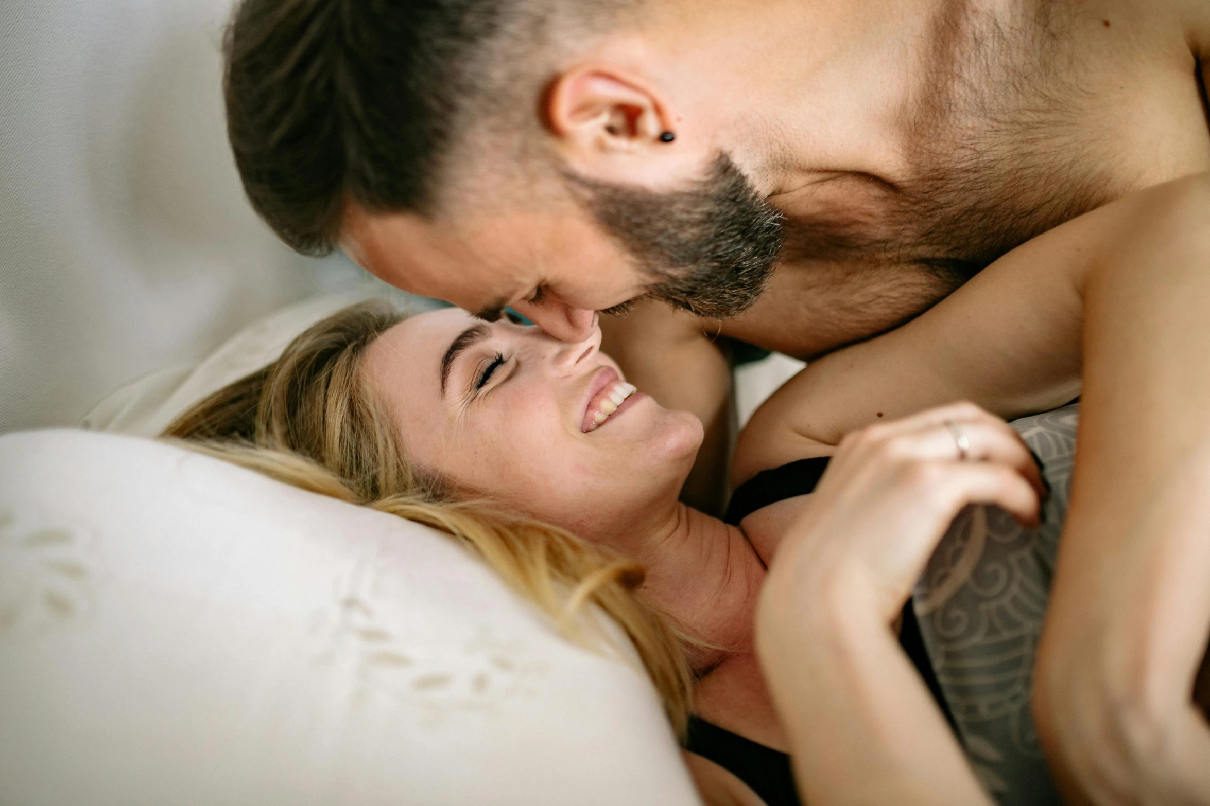a man and a woman laying in bed together, pexels contest winner, kissing smile, bottom body close up, female gigachad, profile image